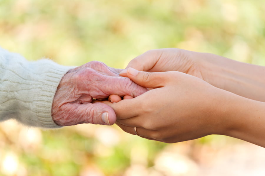 bigstock-Senior-And-Young-Holding-Hands-25847321.jpg